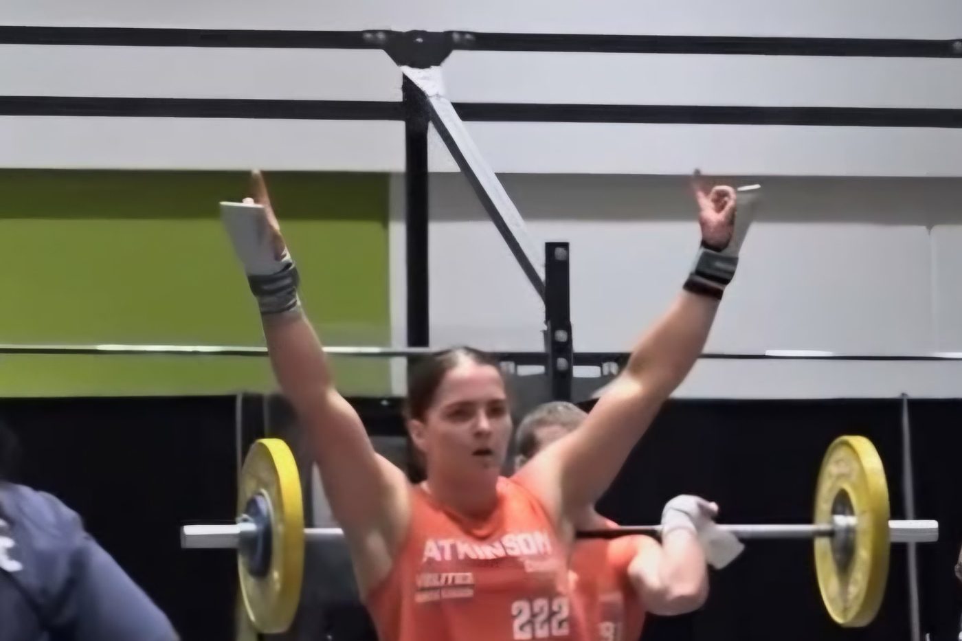 Charlotte Atkinson raising her arms after completing a lift