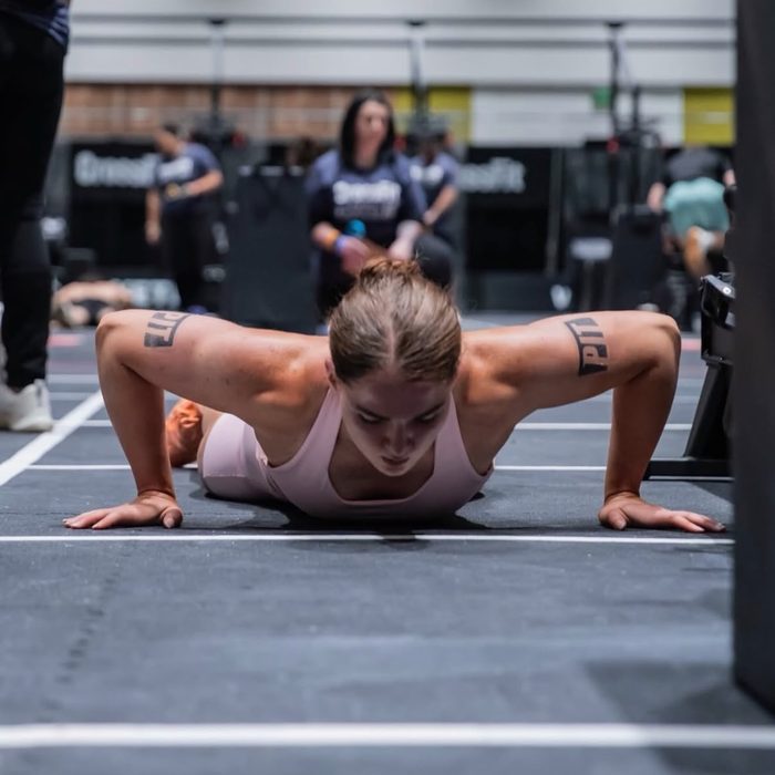 An athlete performing a press-up on a competition floor